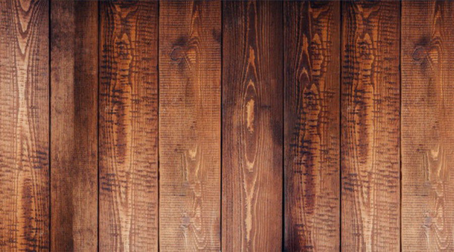 "Topview van een donkere houten vloer met rechte stroken"