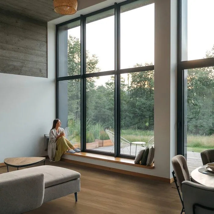 lichte vloer in warm eikenhoutstructuur met brede planken in een moderne woonkamer met grote ramen en minimalistische inrichting