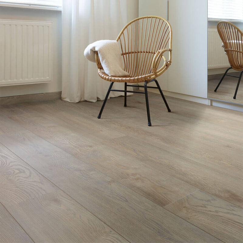 licht beige eiken vloer met brede planken en natuurlijke houtstructuur in woonkamer met rotan stoel en witte radiator